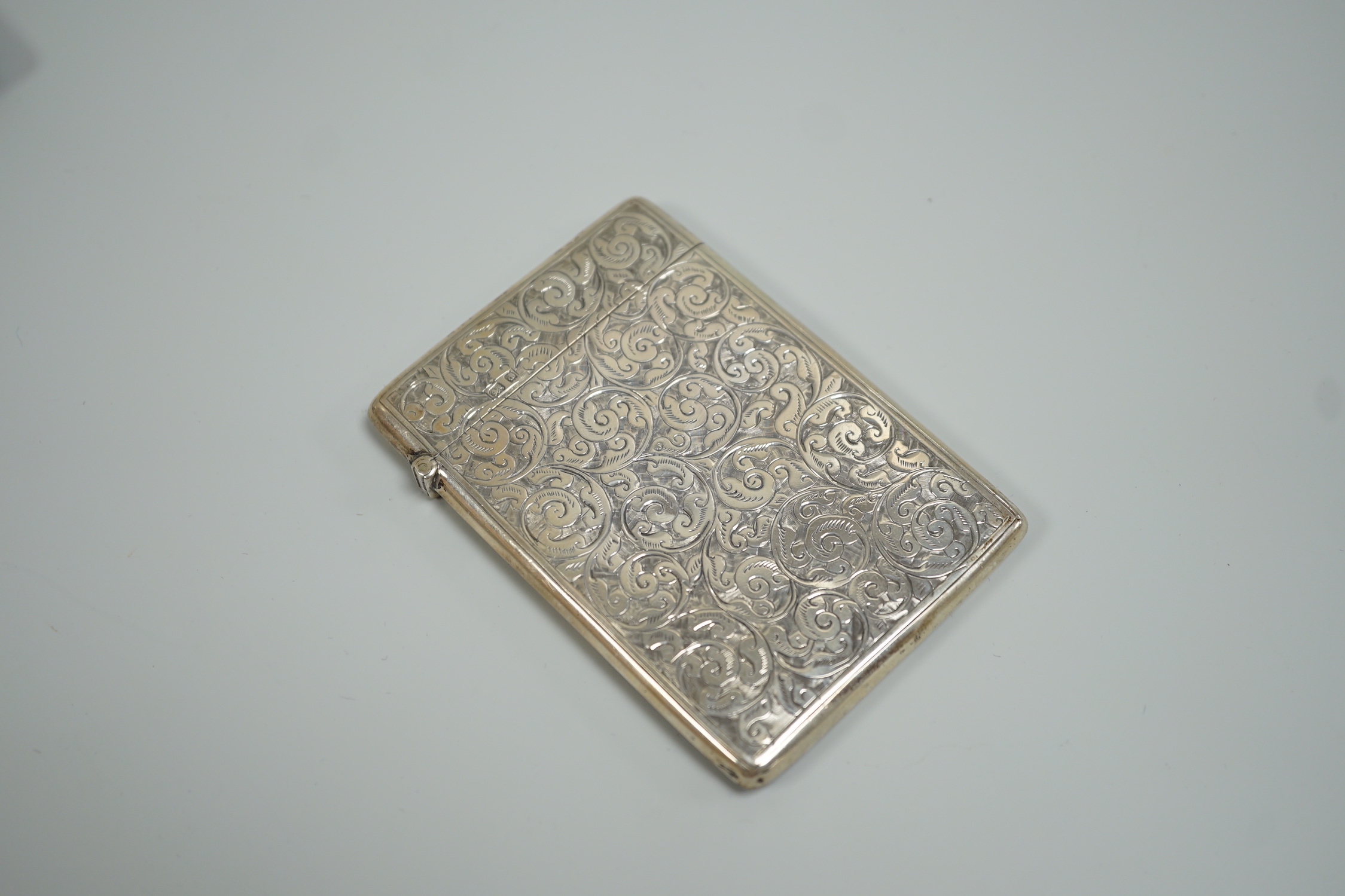 An Edwardian chased silver rectangular card case, Deakin & Francis, Birmingham, 1903, 95mm, in fitted leather case.